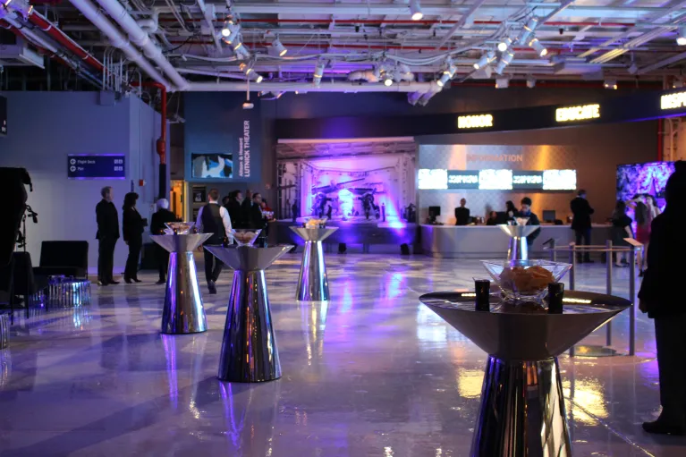 Hangar 1 cocktail reception with silver high top tables and uplighting
