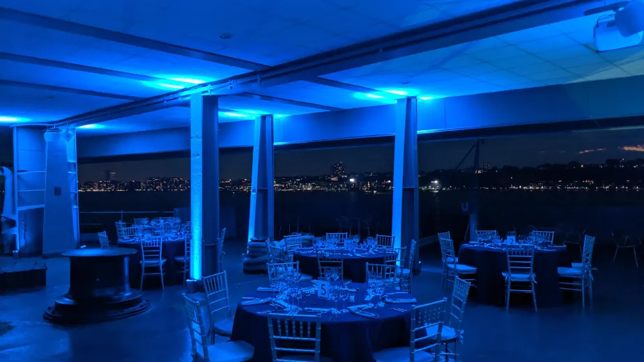 Seated dinner on the Fantail with blue event lighting